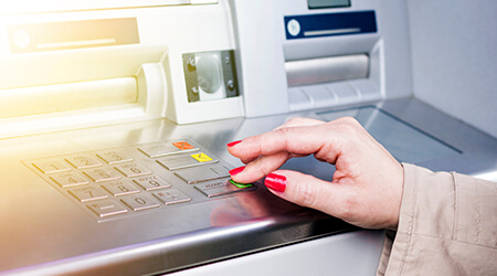 Woman using ATM